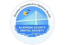 The image features a logo with text that reads  ALAMEDA COUNTY DENTAL SOCIETY  and includes an emblem of a bridge, symbolizing dental health and connectivity.